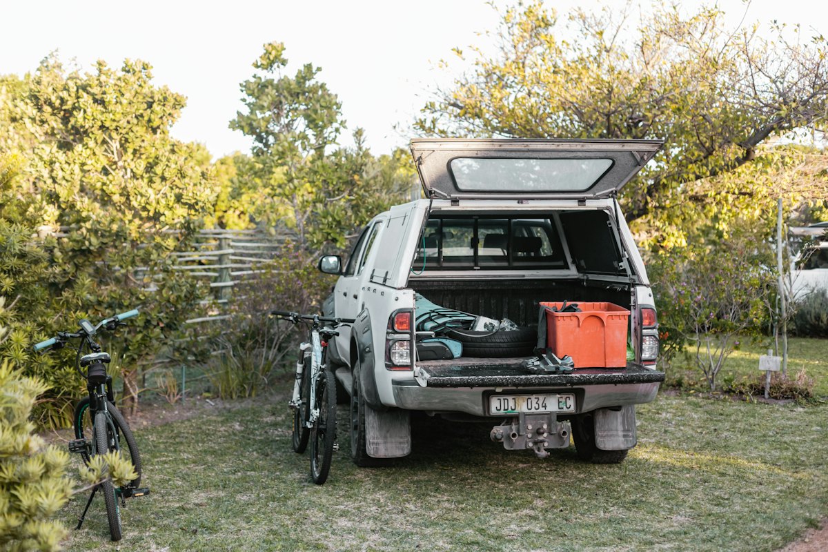 Pickup truck with a covered bed parked on grass