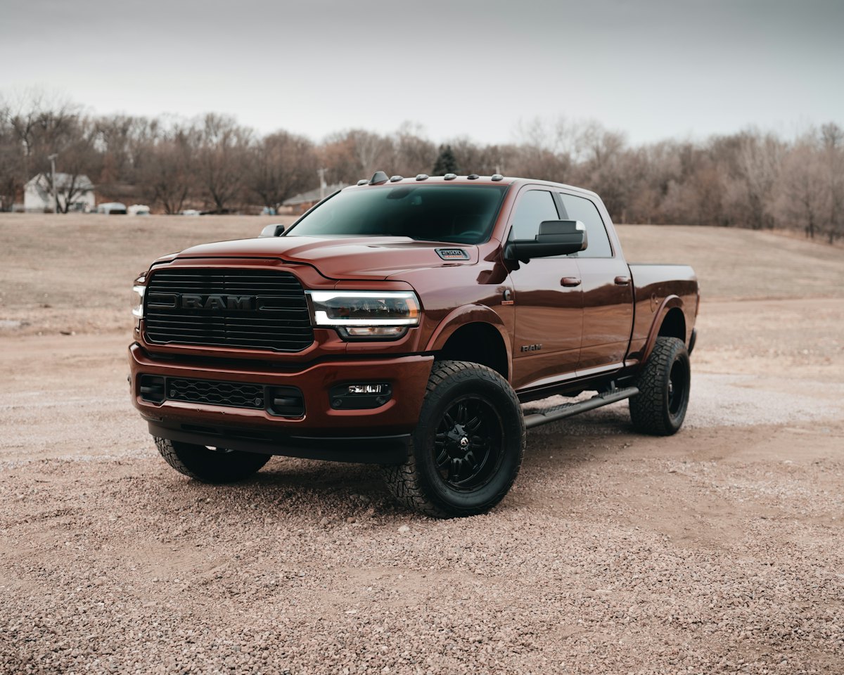 Red heavy-duty pickup truck on a dirt lot