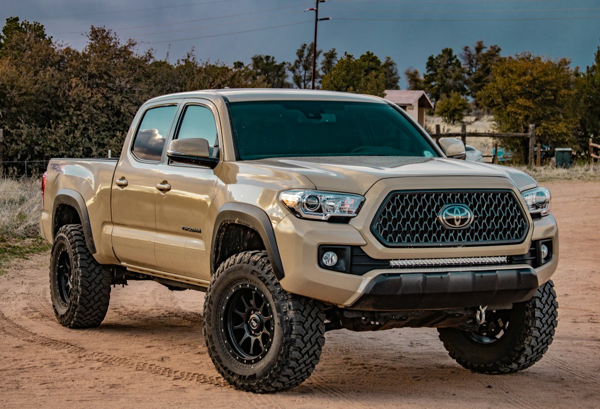 Tan pickup truck on a dirt road