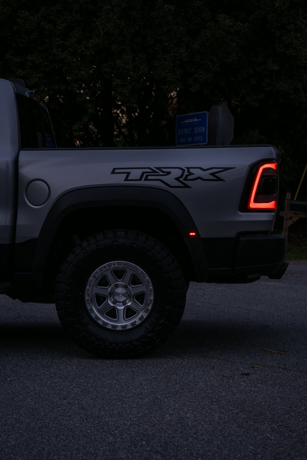 Rear of a dark pickup truck at dusk